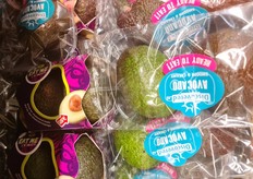 Yex and Nature's Pride avocadoes lying side by side.