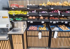 You can take and weigh your own potatoes. To the left of the scale, a barrel containing large pickles.