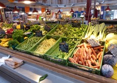 Vegetables presented in green crates.