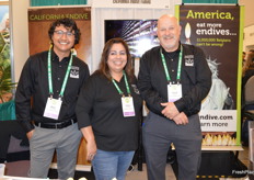Talking with customers and prospects about organic Belgian endive are Sean Quintero, Celina Lemus, and David Moen. The company recently introduced bulk packaging that prevents endive from becoming green. 