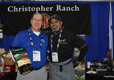 Anthony DeAngelis with Christopher Ranch smiles for a photo with Chef Barry. DeAngelis shows a large garlic pack for foodservice.