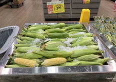 Cobs of fresh corn on ice greet customers as they walk into the store.