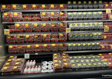 Including whipped cream and fruit dip with this berry display gives consumers ideas.