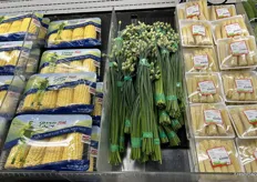 Packaged corn, flowering chive buds and packaged fresh baby corn.