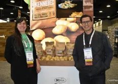 Stacy Reykdal and Christian Cruz with BC Fresh, standing in front of a display of locally grown potatoes.