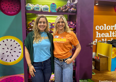 Alex Jackson and Sarah Ardantz with Frieda’s colorful booth filled with equally colorful produce.