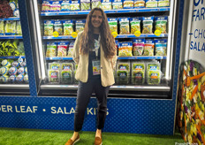 Braga Fresh’s Tatiana Briggs in front of some of the company’s bagged produce.