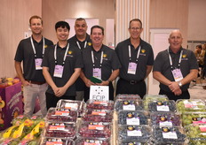 Team Pacific Trellis Fruit behind a display of California grapes.