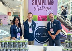 Sujata, Ken, and Josh of Ozblu Blueberries are sampling blueberries at the entrance of the convention center. The company just started up their business in North America.