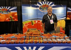 Blue Creek Produce’s Roger Riehm behind many, many tomatoes.