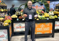 Robert Schueller in front of a wide array of Melissa's Produce.