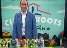 Eric McClam of City Roots stands behind an assortment of his products on display.