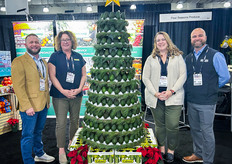 L-R: Wes Jones of Earth Source with Four Seasons Produce Ginny Williams, Traci Sensenig and Wayne Hendrickson all stand around the (avocado!) Christmas tree.