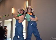 Ladies on stilts welcoming show attendees.