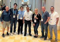 Mango Family smiling for a picture in the hallway of the convention center.