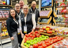 The Red Sun Farms team flanked by fresh, colorful tomatoes.