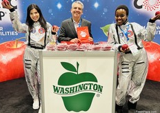 Mark Ebedes flanked by Cosmic Crisp astronauts at the Washington Apple Commission’s booth.