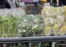 A mix of Asian greens, including Bok Choy and Baby Napa Cabbage, are displayed together.