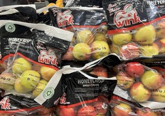 Bags of Canadian Honeycrisp apples piled high.