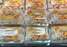 Lots of freshly packed orange-colored Loquat in clamshells.