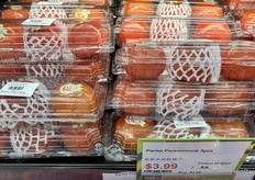 Trios of Spanish persimmons in long clamshells.