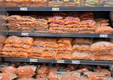 Colored, full size, baby, shredded and carrot sticks on display.