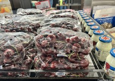 Bags of cherries sit right next to jars of double cream.