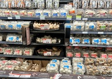 This display features both loose and packaged regular and exotic mushrooms. At the bottom of the display is an explainer about the different varieties of mushrooms and what they’re best used for.