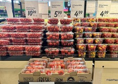 Clamshells of grape, cocktail, medley and Campari tomatoes are stacked high.