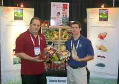 Doug Ranno and Jud Pray of Colorful Harvest presenting Rainbow Carrots, strawberries and red sweet corn