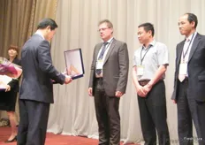 Mr.Ha presenting the award of recognition to Mr. Goeths Rainer, sales director of K&K- Germany; Mr. Sheng Wanlong, CEO of Dalian Quannan Int'l Trade- China and Mr. Li Chun Yuen, purchasing manager of KOFCO- Hongkong.