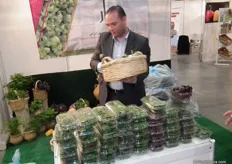 A Palestinean exhibitor presents his fresh herbs on the television.