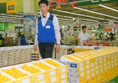 a worker ready to assist customers at the Nonghyup Hanaro Mart