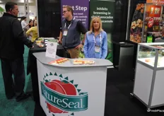 Celyne Goulet from NatureSeal and Brendan Foley behind her talking to a customer.
