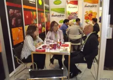 At a busy Mehadrin stand: Sharon Barak and Sandra Greif with Giulio Magrini from Agricola.