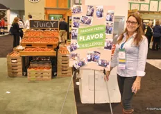 Helen Aquino from Village Farms stand next to a board with several photos of customers who already participated in the Challenge. These photos are also on Instagram