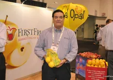 Keith Matthews from FirstFruits holds the a new bag with Opal apples. Opal doubled the production this year from last year. The company also has new packaging they use ultramesh.