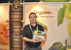 Luis Acuña from VivaTierra holds a bag with Italian organic kiwis. A new item they sell at the East Coast.