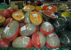 Various varieties of melon, half or whole.
