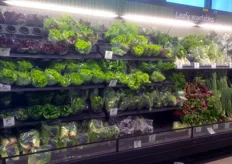 A lovely display of fresh vegetables and (below) aromatic herbs in trays.