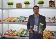 Stephen Cowan from Mucci Farms holds in his left hand the hot peppers. At the box of the peppers, they inform how hot it is by the colors.