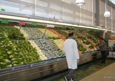 Vegetables are kept fresh by a water spraying system