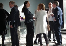 Visitors have a cup of coffee during the morning reception.