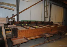 This is also an original grading machine that sorts the fruit according to size. It is cranked by hand, and still works.