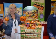 Michele Youngquist with Bay Baby Produce has weebee little pumpkins with hats and hair on display.