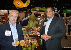 Bill Schneider and Carlos Preciado with Melissa's show baby pineapple, star fruit, mangosteen and dragon fruit.