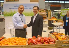 Giden Feiner with Polymer Logistics and Dorn Wenninger from Walmart shaking hands on the partnership to introduce wood-grain crates at Walmart stores.