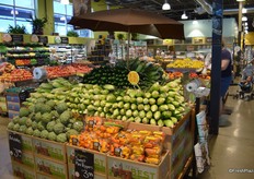 Zucchini, sweet corn, artichokes and sweet mini peppers on display.