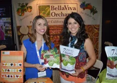 Kelsey Nunes and Brean Bettencourt with BellaViva Orchards, showing their new product: dried apple slices.