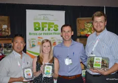The team of Farmington Fresh: Ernie Pascua, Jennifer Lima, Garrison Rajkovich and Daniel Rajkovich. They show a new product: Bites of Fresh Fruits. Each clamshell contains individually packaged bags with pre-cut fruit.